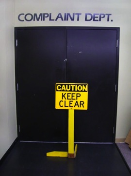 Complaint Departments Entrance with Caution Keep Clear Sign